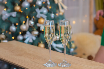 glasses with champagne on the background of a christmas tree in christmas close-up