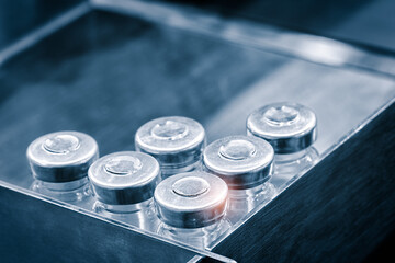 Glass bottles in production in the tray of an automatic liquid dispenser, a line for filling medicines against bacteria and viruses, antibiotics and vaccines.