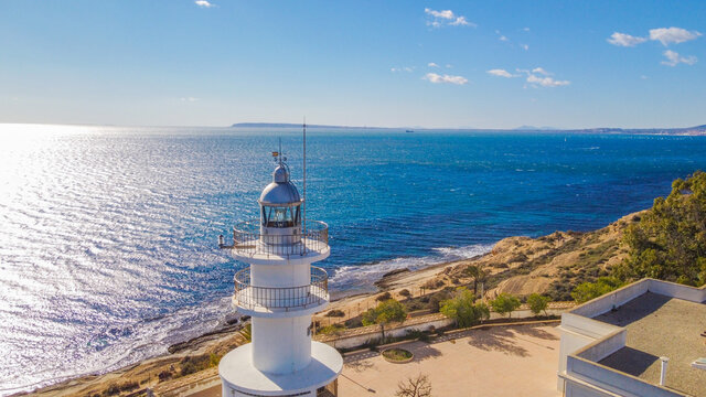 Faro del Cabo de las Huertas en Alicante , vista a&eacute;rea en un d&iacute;a luminoso y con el mar peinado por el fuerte viento de poniente y con un fuerte color azul del mar.
