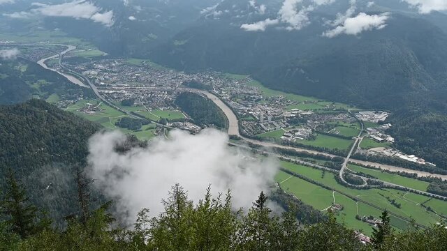 Aerial view of the city of Kufstein, Austria from a mountain. Clouds are passing by.