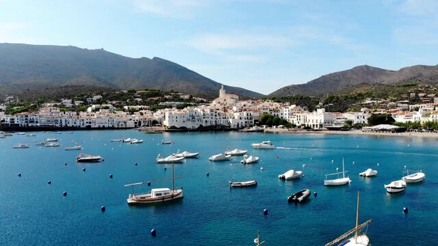 Drone shot Santa Maria de Cadaqu&eacute;s Drone view of a small village on the Costa Brava in Cadaqu&eacute;s. Boats in a rocky bay in Cadaques. View from the drone of the beach and the bay in Cadaques. 