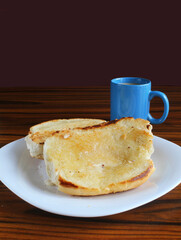 Bread with butter and mug of coffee and milk. Brazilian breakfast.