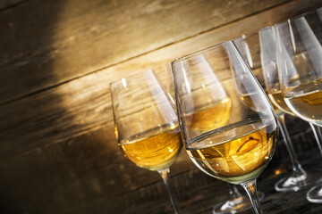 Obraz premium Refreshing White Wine in a Glasses on Wooden Background