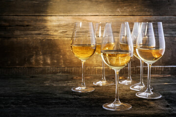 Refreshing White Wine in a Glasses on Wooden Background