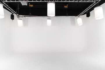 An empty large white photo studio for shooting large objects, cars or people. seamless white...