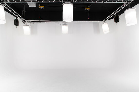 An empty large white photo studio for shooting large objects, cars or people. seamless white cyclorama