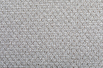 Grey fabric texture. Furniture upholstery textiles. Embossed pattern. Woven fibers. The material is soft touch. Minimalism concept. High detail macro photography for backgrounds or wallpapers.