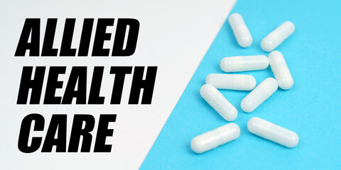 There are pills on the blue surface, on the white surface it says - Allied Health Care