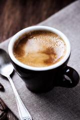 Cup of coffee on dark background. Close up.