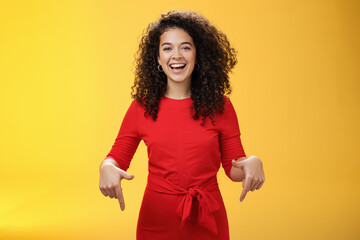 Waist-up shot of assertive charming and happy young woman with curly hairstyle laughing joyfully,...