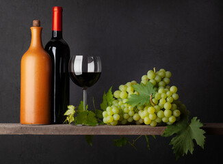 Fototapeta na wymiar White grape, bottles and red wine glass
