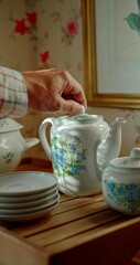 Hand of a man who is using a tea service