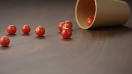 fresh cherry tomatoes spill on walnut table