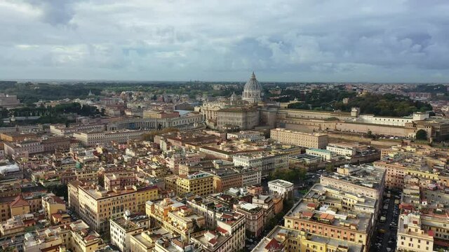 Aerial drone video of iconic masterpiece world famous Saint Peter Basilica and Sistine chapel in city of Vatican the biggest church in the world, Metropolitan city of Rome, Italy