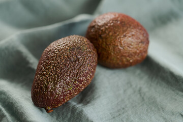 Two avocados on linen cloth