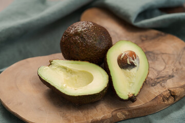 Ripe avocados on olive wood board