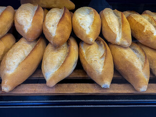 Loaves of bread lined up on the counter