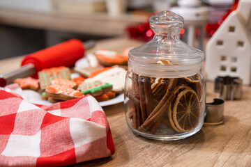 Fototapeta na wymiar Christmas culinary background with cinnamon sticks and homemade gingerbread cookies.