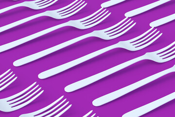 Rows of forks on violet background. 3d render