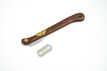 Bread making straight black walnut lame with an extra razor blade on a white background