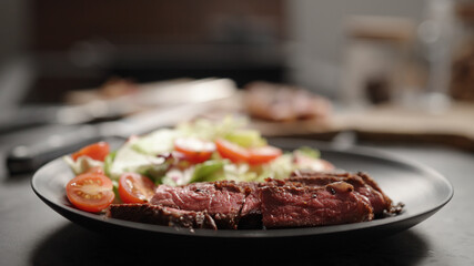 slices of new york steak on plate with mixed vegetables