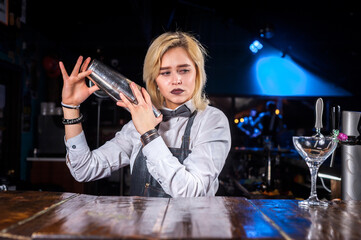 Girl bartender concocts a cocktail on the brasserie