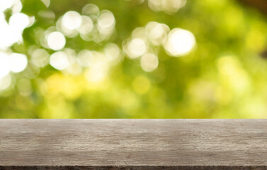 Rustic wooden table on outdoor forest blurred background.