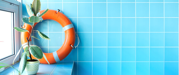 lifebuoy on the blue tile background banner copy space for text. marine or swimming pool background