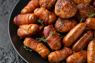 Pigs in Blankets, cocktail sausages and meatballs on plate. Party food