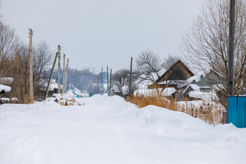 The winter village of Krasny Yar of the small indigenous peoples of the north of Russia - the Udege. Street in the village in winter. Wooden Russian huts in a beautiful village.