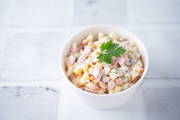 Potatoes green peas carrots sausage salad with mayonnaise