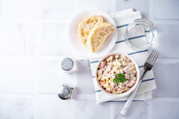 Potatoes green peas carrots sausage salad with mayonnaise