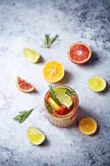 Obraz na płótnie Canvas Red orange lime lemon cocktail in a glass