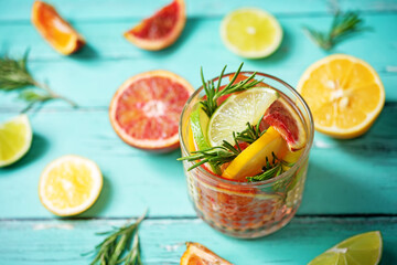 Red orange lime lemon cocktail in a glass