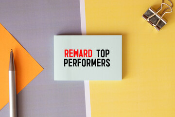 Reward top performers text memo written on a white background with pencils.