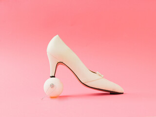 White shoes and white new year ball  on pink background. art concepy