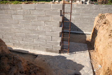 Brick foundation wall made of blocks and cement. Construction of a modern home