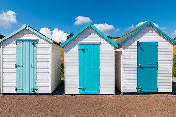 Fototapeta na wymiar Colorful small beach houses. Multicolored beach sheds. Variety of painted beach shacks. Beach hut. 