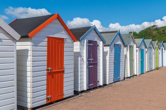 Colorful small beach houses. Multicolored beach sheds. Variety of painted beach shacks. Beach hut. 