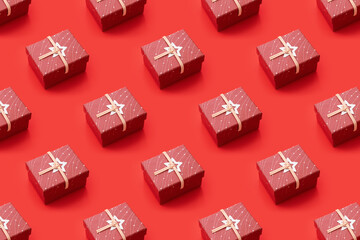 Trendy pattern made with gift box on bright red background. Minimal concept
