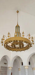 Large chandelier made of gold colored metal. Antique large chandelier.