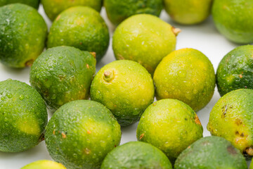 Fresh little limes on pure white background