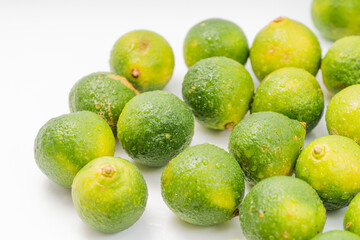 Fresh little limes on pure white background