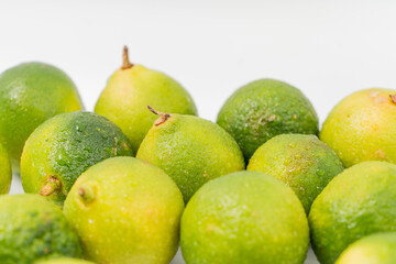 Fresh little limes on pure white background