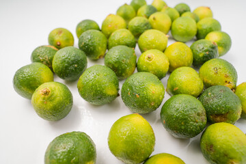 Fresh little limes on pure white background