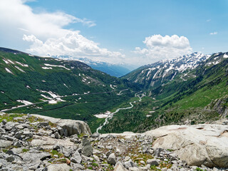 Fototapeta na wymiar Furka Pass, Switzerland view from Rhone Glacier showing the Rhone River and Furkastrasse