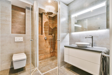 Flush toilet and shower cabin with glass partition in washroom at home