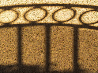 4-Ring Iron Gate Shadow on Plastered Wall