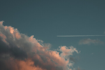 Naklejka na ściany i meble Sky with clouds and a wake of an airplane