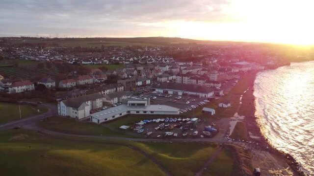 Sun setting over Prestonpans Beach and town during winter. East Lothian, Scotland